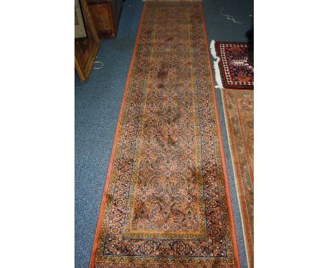 A HERATI DESIGN CARPET RUNNER, pure wool pile, terracotta ground with traditional foliate motifs, approximate size length 328