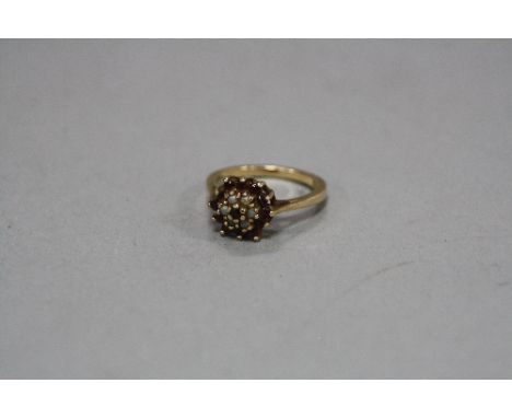 A 9CT GARNET AND SEED PEARL CLUSTER RING, size N