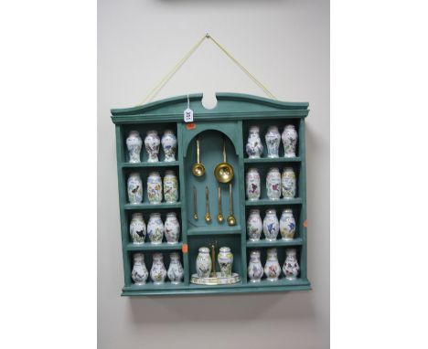 A PAINTED SPICE RACK, with twenty six Lennox ceramic spice jars and five graduating spoons