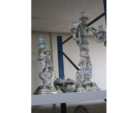 TWO CONTINENTAL CERAMIC CANDLEABRAS, one in need of restoration (2)