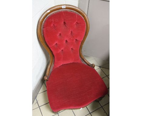 A VICTORIAN BUTTON BACK BEDROOM CHAIR, covered with red upholstery