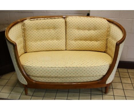 AN ART DECO STYLE TWO SEATER SOFA, with arched back and arms