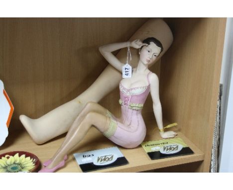 VITOS ADVERTISING ITEMS FOR FRENCH STOCKINGS, to include resin figurine in corset, a model leg and two plaques (4)