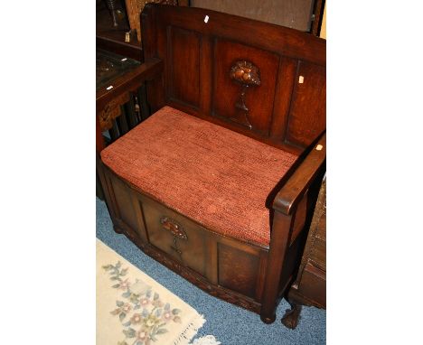 AN OAK MONKS BENCH, with carved floral detail and removable cushion, approximate size width 91cm x depth 45cm x height 73cm