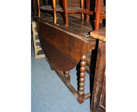 AN EARLY 20TH CENTURY OAK OVAL GATE-LEG TABLE, with bobbin turned supports, approximate size 154cm x width 130cm x height 76c