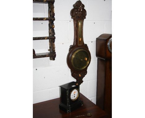 A SLATE MANTLE CLOCK, with circular enamel face and an oak aneroid brass faced barometer, W.Smith, Crowland