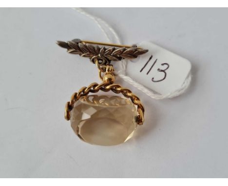 A citrine swivel fob set in gold with silver brooch 