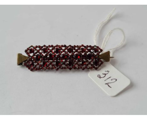 A vintage lattice garnet brooch