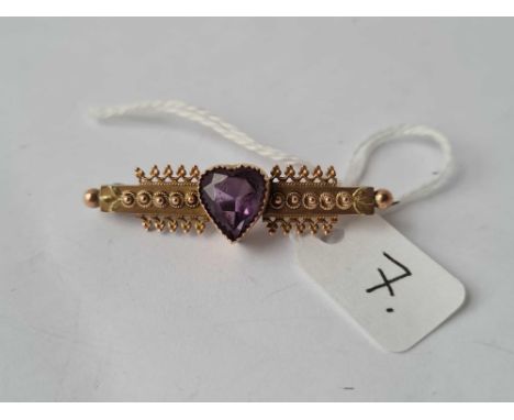 A good fancy bar brooch with large heart amethyst to centre set in gold 