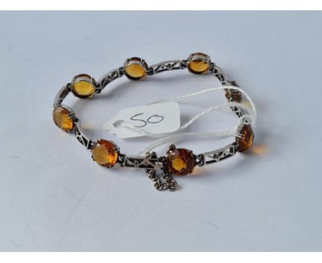 AN EDWARDIAN CELTIC STYLE CITRINE BRACELET IN 9CT WHITE GOLD - 8.6gms