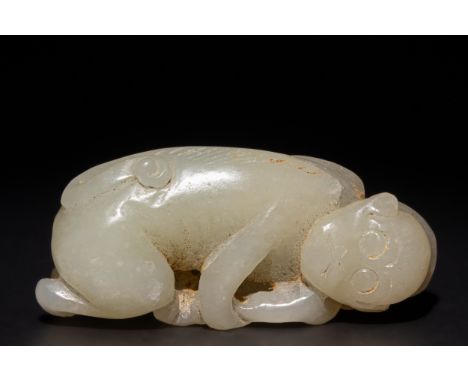 A Chinese Carved Jade Figure of a Reclining Monkey.This finely carved Chinese jade sculpture depicts a reclining monkey in a 