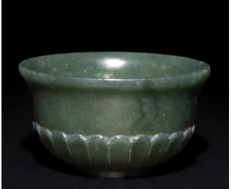An Indian Mughal Jade Bowl with Petal-Shaped Decoration.This Indian Mughal jade bowl is crafted from translucent green jade, 