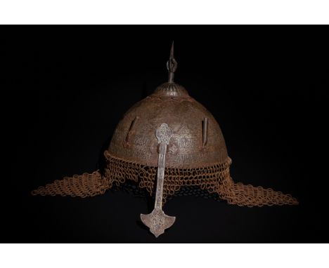 An Islamic Indo-Persian Kulah-Khud Helmet with Calligraphic Engraving and Chainmail.It features exquisite Islamic calligraphy