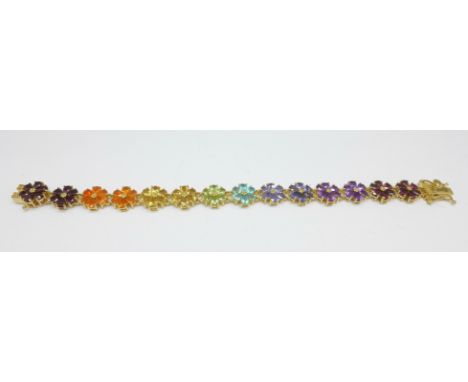 A silver gilt multi-gem set bracelet including tanzanite, fire opal, apatite, garnet, etc. 