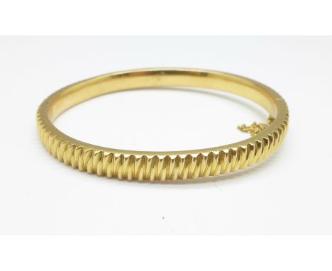 A yellow metal bangle, with continental control marks, 16g 