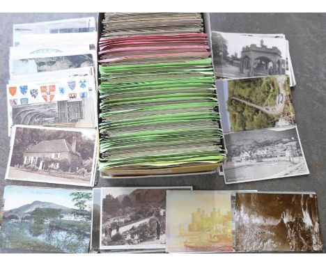 A box of approximately 600 vintage postcards, sorted into categories 