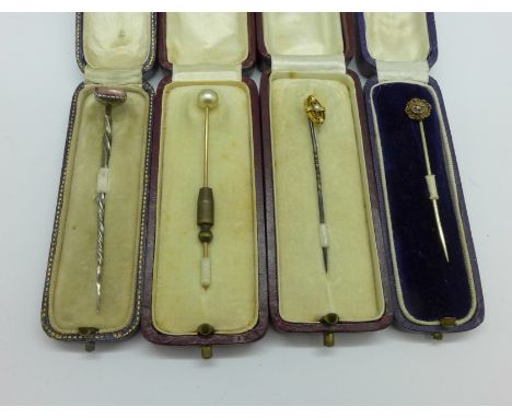 Four stick pins, one marked 9ct and set with pearl, one set with a diamond 