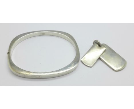 A silver bangle and a silver pendant, 28g 