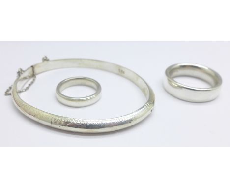 Two silver rings and a silver bangle 