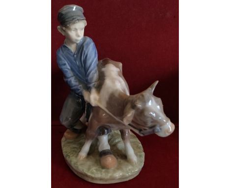 ROYAL COPENHAGEN GLAZED CERAMIC FIGURE DEPICTING A BOY WITH CALF REASONABLE, USED CONDITION
