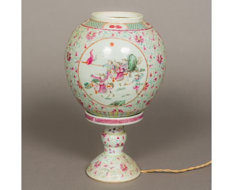 A Chinese porcelain table lamp and shadeWorked with courtly and warring figural vignettes, on a lotus strapwork ground, the b