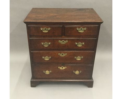 An 18th century oak chest of drawers
Of small proportions, the moulded rectangular top above an arrangement of two short and 