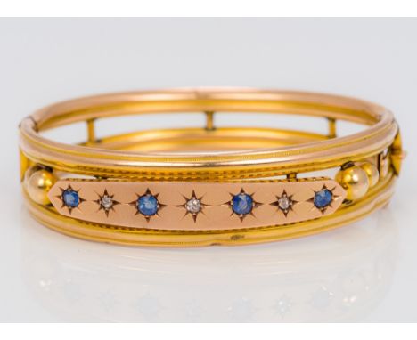 A 9 ct gold sapphire and diamond set bangle form bracelet
Of pierced tubular form, set with alternating sapphires and diamond