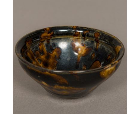 A Chinese Song Dynasty pottery bowlWith allover treacle glaze.  12 cm diameter. Provenance: From the late Harry Lakin Collect