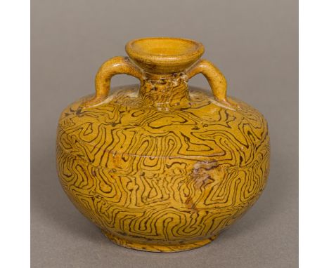 A Chinese Tang Dynasty pottery twin handled vase
With marbled decoration.  9.5 cm high.
Provenance: From the late Harry Lakin