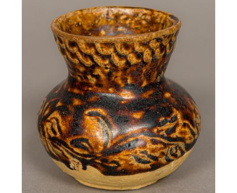 A Chinese Tang Dynasty pottery vaseWith moulded decoration and treacle glaze.Provenance: From the late Harry Lakin Collection