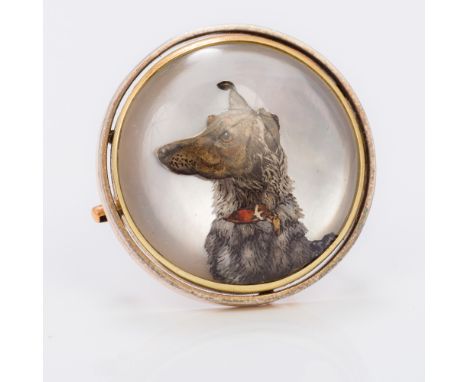 A gold framed Essex crystal broochOf circular form, centred with the portrait bust of a dog.  2.5 cm diameter.  CONDITION REP