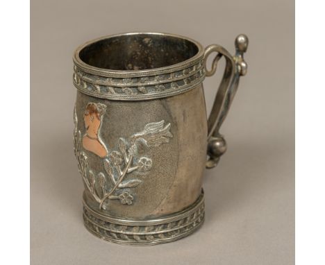 An unusual white metal tankardThe top set with a twin row of leaves above the scrolling snake and figurally handle, the front