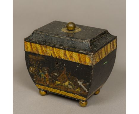 A 19th century toleware tea caddy
The hinged top with lacquered brass finial, above the bowed tapering main body, the front d