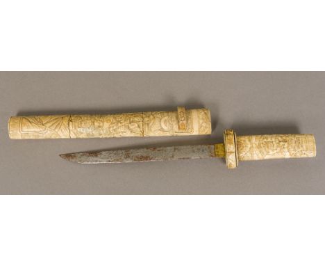 A 19th century Japanese carved bone tanto The handle and scabbard typically worked with figures in traditional costume. The s