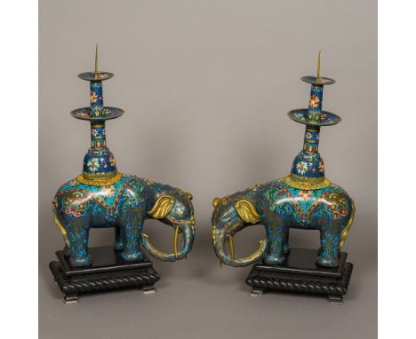 A pair of Chinese cloisonne type decorated pricket stick censersModelled as elephants, both standing on ebonised wooden plint