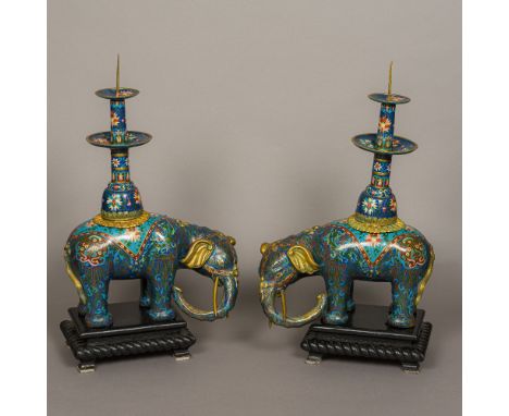 A pair of Chinese cloisonne type decorated pricket stick censersModelled as elephants, both standing on ebonised wooden plint