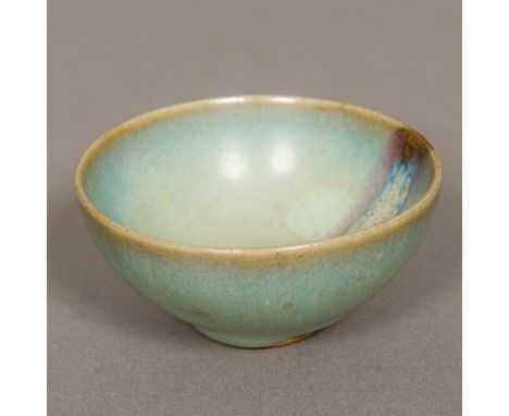 A Chinese Jin Dynasty Jun Ware pottery bowlWith typical glaze.  8 cm diameter.Provenance: From the late Harry Lakin Collectio