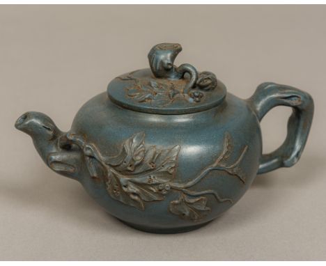 A Chinese Ying Ying pottery teapot Of globular form, with leaf decoration, the lid surmounted with a rodent, with allover blu