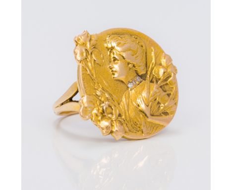 A 14 K gold Art Nouveau ring Embossed with a young lady wearing a diamond collar, holding floral sprays, signed E Dropsy.  2.