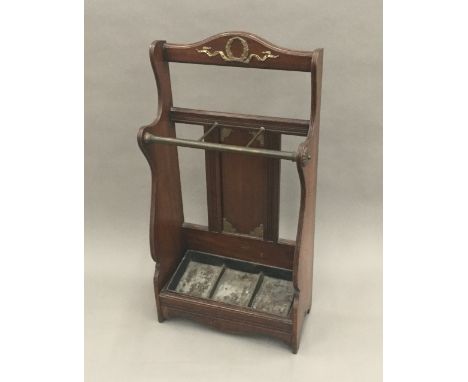 A Victorian Arts &amp; Crafts brass mounted walnut stick/umbrella stand, in the manner of James Shoolbred
With applied plaque