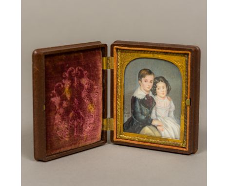 A 19th century portrait miniature on ivoryDepicting a young boy and girl inscribed Julian et Elizabeth 1865, signed with mono