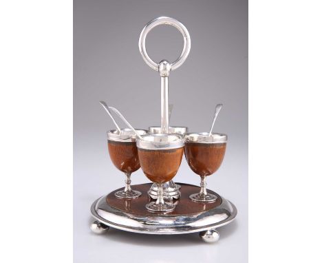 A VICTORIAN SILVER AND OAK EGG CRUET, by Percy Holland &amp; George Gibson, London 1877, the circular stand with four egg cup