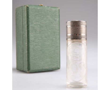 A FRENCH SILVER-MOUNTED SCENT BOTTLE, late 19th/early 20th Century, the cylindrical glass body etched with scrollwork, the en