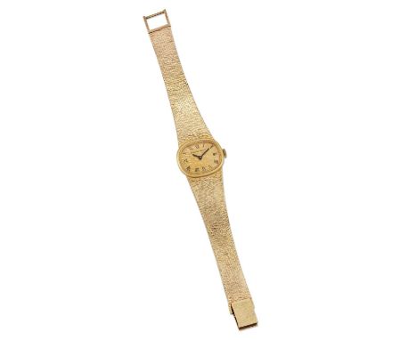 A 9 CARAT GOLD BUECHE GIROD BRACELET WATCH, the oval textured gold dial with black hands and Roman index, signed Bueche Girod