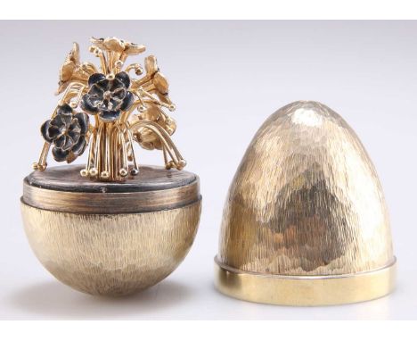 AN ELIZABETH II SILVER-GILT AND ENAMEL SURPRISE EGG, by Stuart Devlin, London 1979, the textured and planished silver-gilt eg