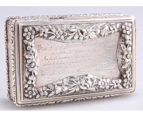 A VICTORIAN SILVER SNUFF BOX, by Edward Smith, Birmingham 1846, rectangular, the hinged cover with boldly chased raised flora