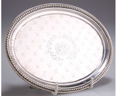 A 19TH CENTURY AMERICAN STERLING SILVER TEAPOT STAND, by J.E. Caldwell &amp; Co, oval, with beaded rim and bright-cut engrave