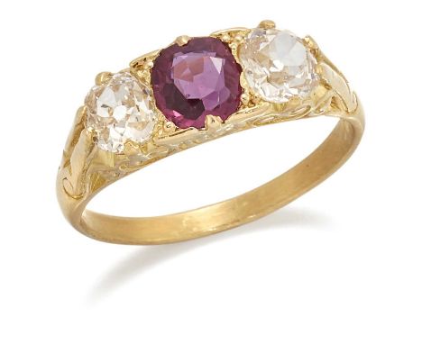 A RUBY AND DIAMOND THREE STONE RING, a cushion-cut ruby spaced by old-cut diamonds above a carved gallery. Estimated total di