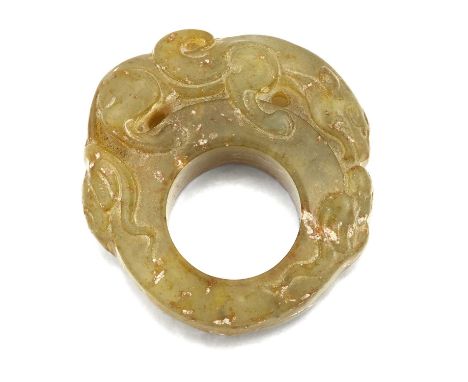 A CARVED JADE THUMB RING, surmounted by a qilin. 5.2cm by 5cm