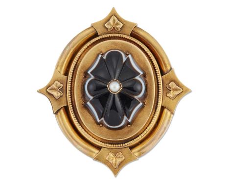 A MID 19TH CENTURY BANDED AGATE AND SPLIT PEARL BROOCH, a carved banded agate set with a split pearl, within a fancy oval fra